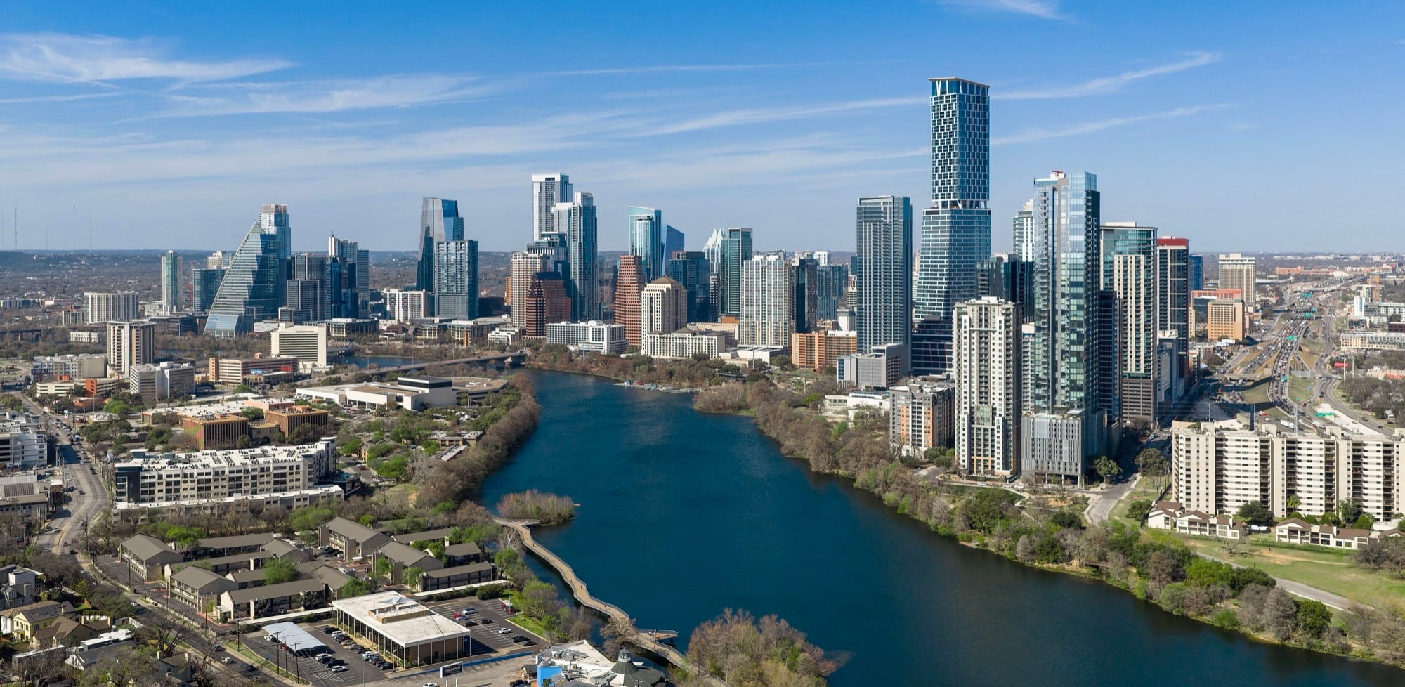 Aerial view of downtown Austin and Lady Bird Lake, with I-35 and the east side along the right edge