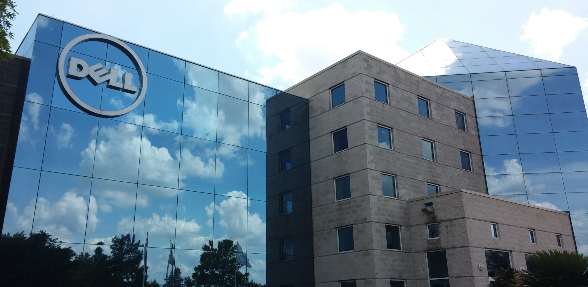 Dell’s headquarters in Round Rock, a glass office building with the Dell logo beside a stone tower