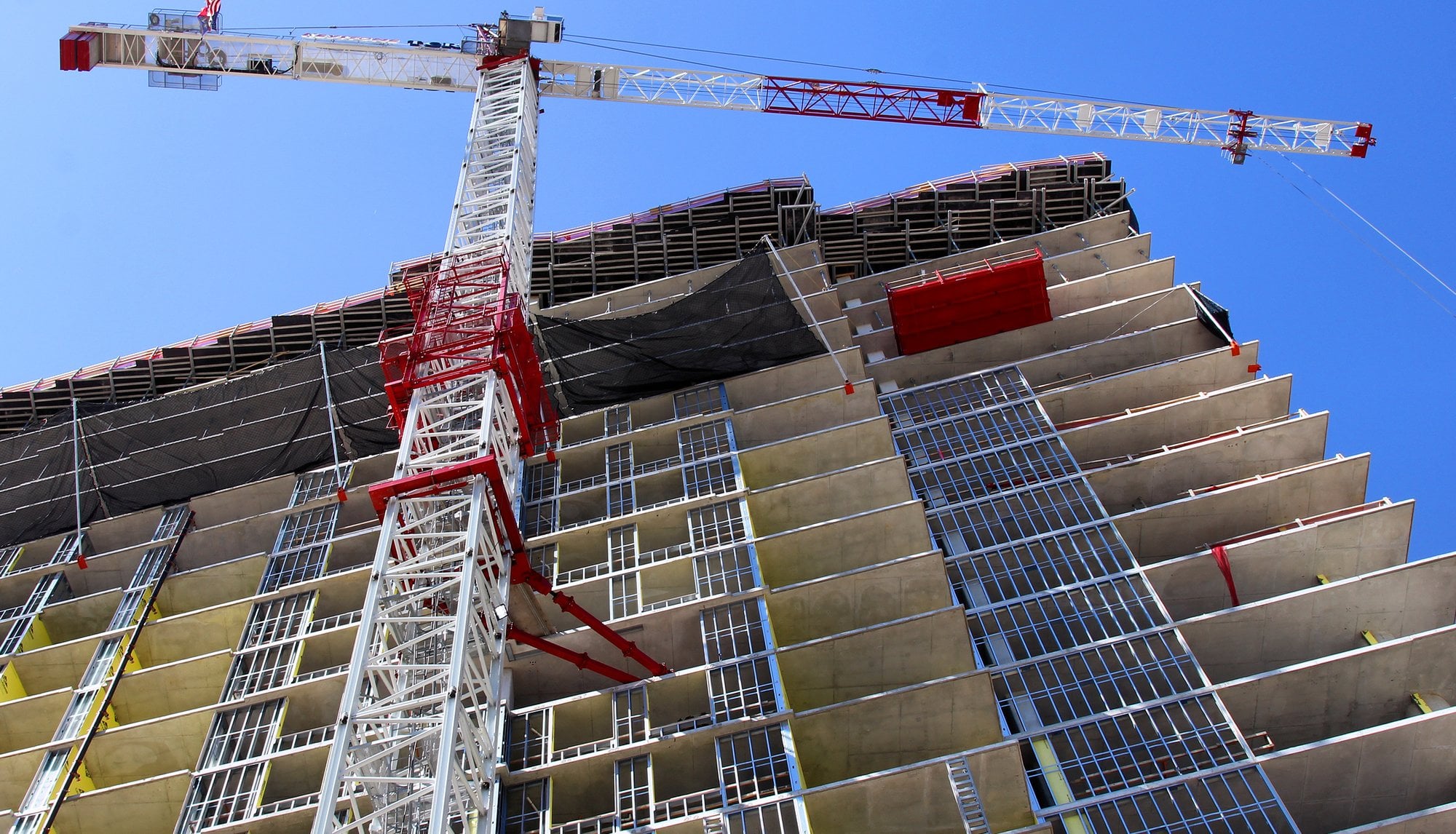 A tower crane beside a high-rise under construction in Austin